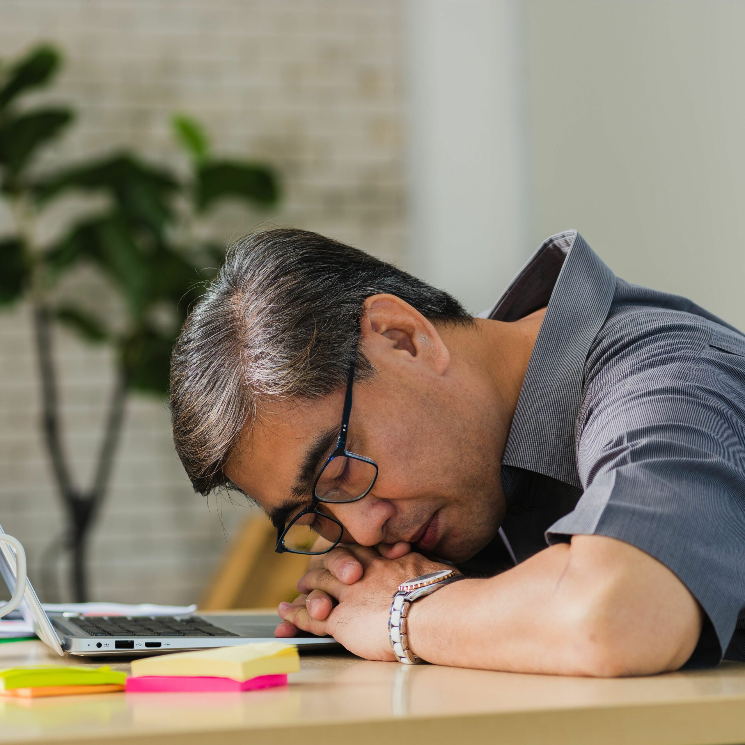 Man tired from work because low NAD+ levels can make chronic pain and fatigue worse.