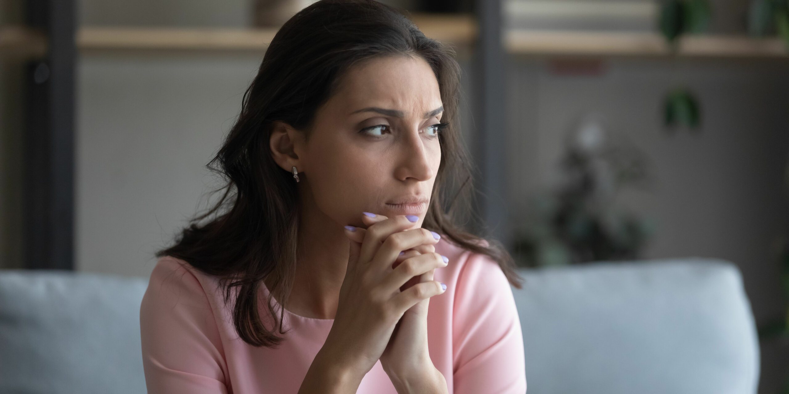 Worried woman sitting alone